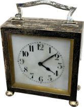 1920's Birmingham silver clock. Swing handle, square form and raised on bun feet. [9x8x3.5cm]