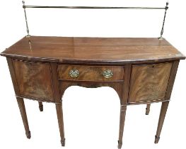 Antique Walnut and mahogany sideboard, the brass top rail above a bow shaped surface, one central