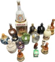 A Collection of whisky decanters and flagons; Dimple, Bells, Robert the Bruce, The Black Prince