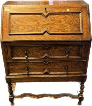 Antique oak writing bureau, the fall front opening to reveal a fitted interior, above two long