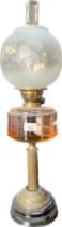 Antique glass and brass base paraffin lamp, Glass funnel and globe present. [69cm high]