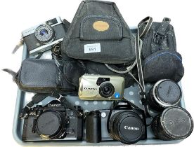 Collection of vintage camera items; Canon EOS 500 camera with lens, Canon A-1 Camera with lens,