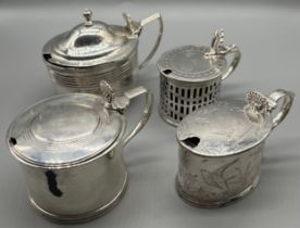 A Lot of four antique silver lidded condiment pots. All have blue liners present- signs of damage to