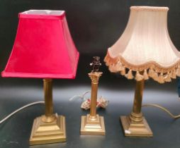 A collection of Three antique brass Corinthian column brass table lamps