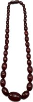 A Graduating cherry amber bead necklace. [22cm drop] [31.80grams]