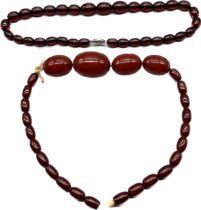 Two vintage Cherry amber coloured bead necklaces; Necklace with four large beads is cherry amber and