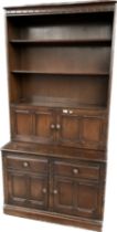Ercol dresser, the moulded cornice over three open shelves and two cupboard doors, the lower cabinet