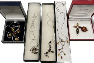 A Selection of Amber and silver jewellery; Three various silver and amber necklaces, Two cross