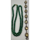 A Vintage necklace of Malachite beads finished with a 9ct yellow gold clasp and catch. Together with