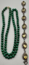 A Vintage necklace of Malachite beads finished with a 9ct yellow gold clasp and catch. Together with