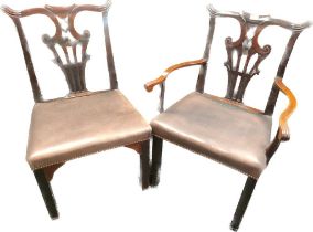 Georgian his and hers Chippendale style chairs, upholstered with a brown leather.