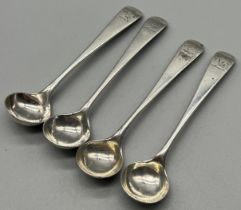 A Set of four Victorian Edinburgh silver condiment ladles. Engraved with insignias to the handles