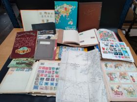 A large collection of mixed world stamps includes albums & A scrap book album of comical Henry cards