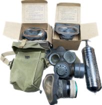 A lot of four- world war gas masks; 3 in original boxes along with a vintage fire extinguisher