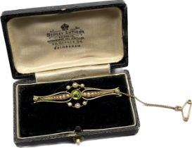 Early 1900's 15ct yellow gold ornate bar brooch; designed with a centre round cut green tourmaline