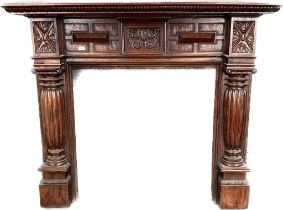 An antique style heavily carved mahogany fire surround [130x152x29]