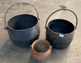 Two large antique witches cauldrons along with small witches cauldron