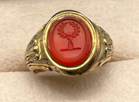 Antique 9ct yellow gold and red agate stone seal ring. Seal- depicts hand holding a wreath. [Ring