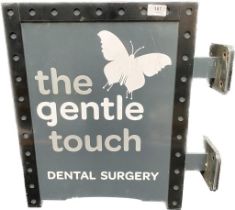 A vintage metal dental advertisement sign 'the gentle touch dental surgery'