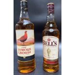 A bottle of famous grouse scotch whisky & A bottle bells blended scotch whisky.