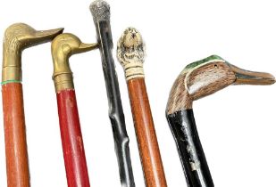 A collection of walking Canes to include silver hall marked topped swagger stick & novelty topped