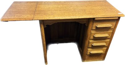 Antique knee hole oak desk. The rectangular top with drop end above a pullout ledge and bank of four