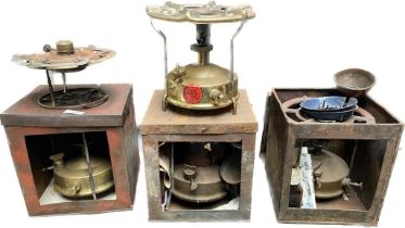 A collection of vintage paraffin stoves includes primus