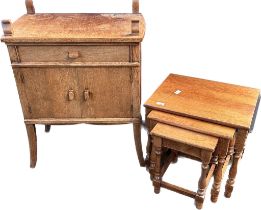 Oak nest of tables together with an oak cupboard unit raised on shaped legs