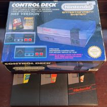 Vintage boxed Nintendo Nes console with three games; Super Mario Bros., Double Dragon and Super