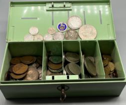 A Vintage money box containing a mixed selection of British coins and some world coins; various