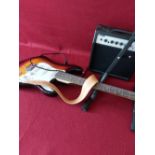 Electric guitar with stand and amp.