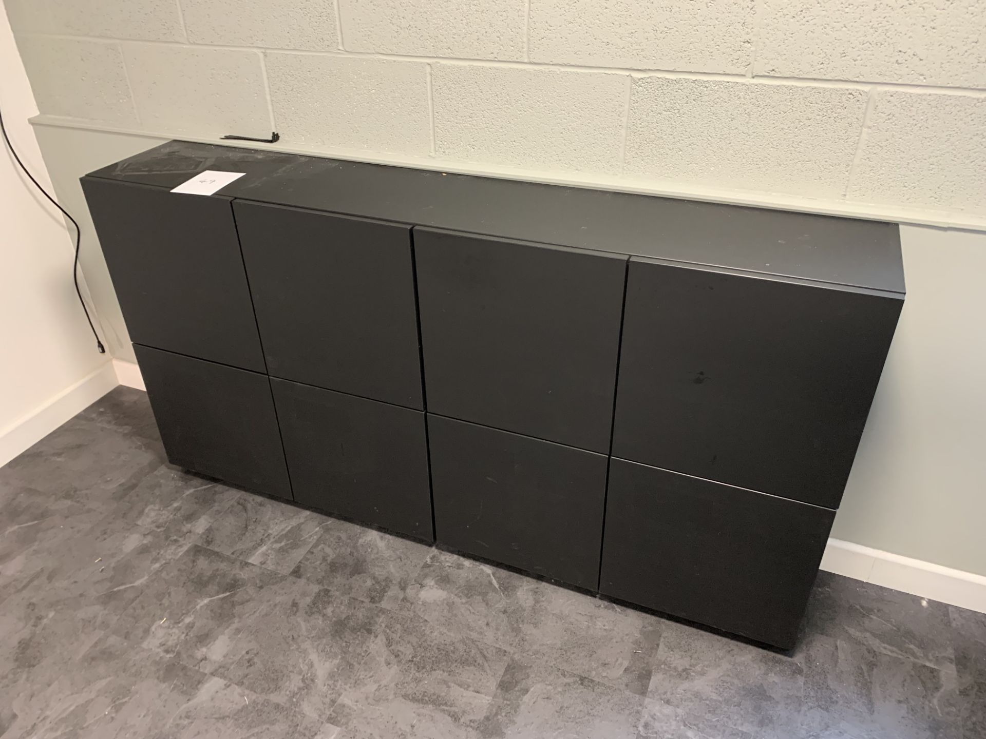 Black cupboard unit with 8 separate square cupboards