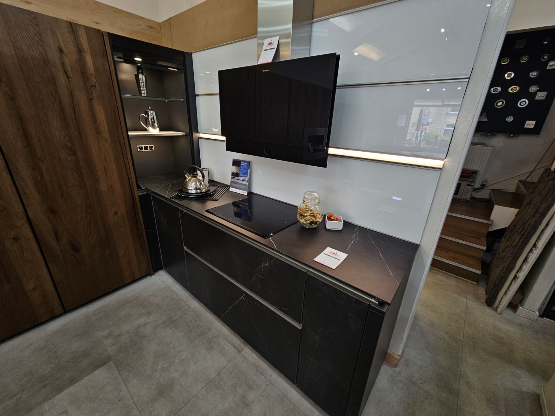 Display kitchen comprising black marble effect base unit cupboards and drawers