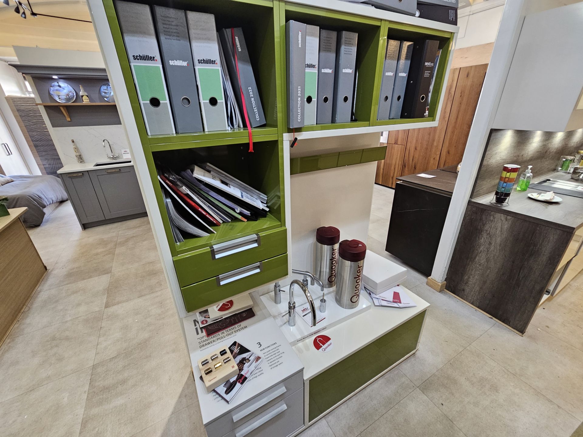 White and lime green office display unit, Quooker display items and assorted sample books