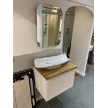 Display bathroom sink on floating pedestal with mirror