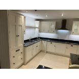 Display L-shaped kitchen in flat white with black granite work surface