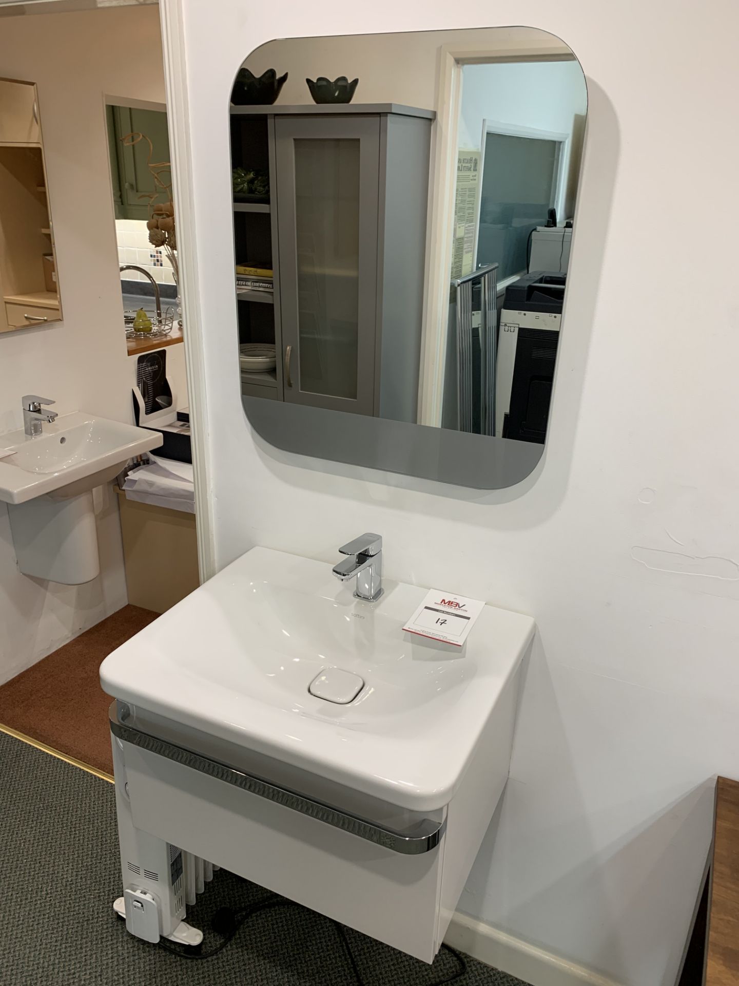 Display bathroom sink on floating pedestal with mirror