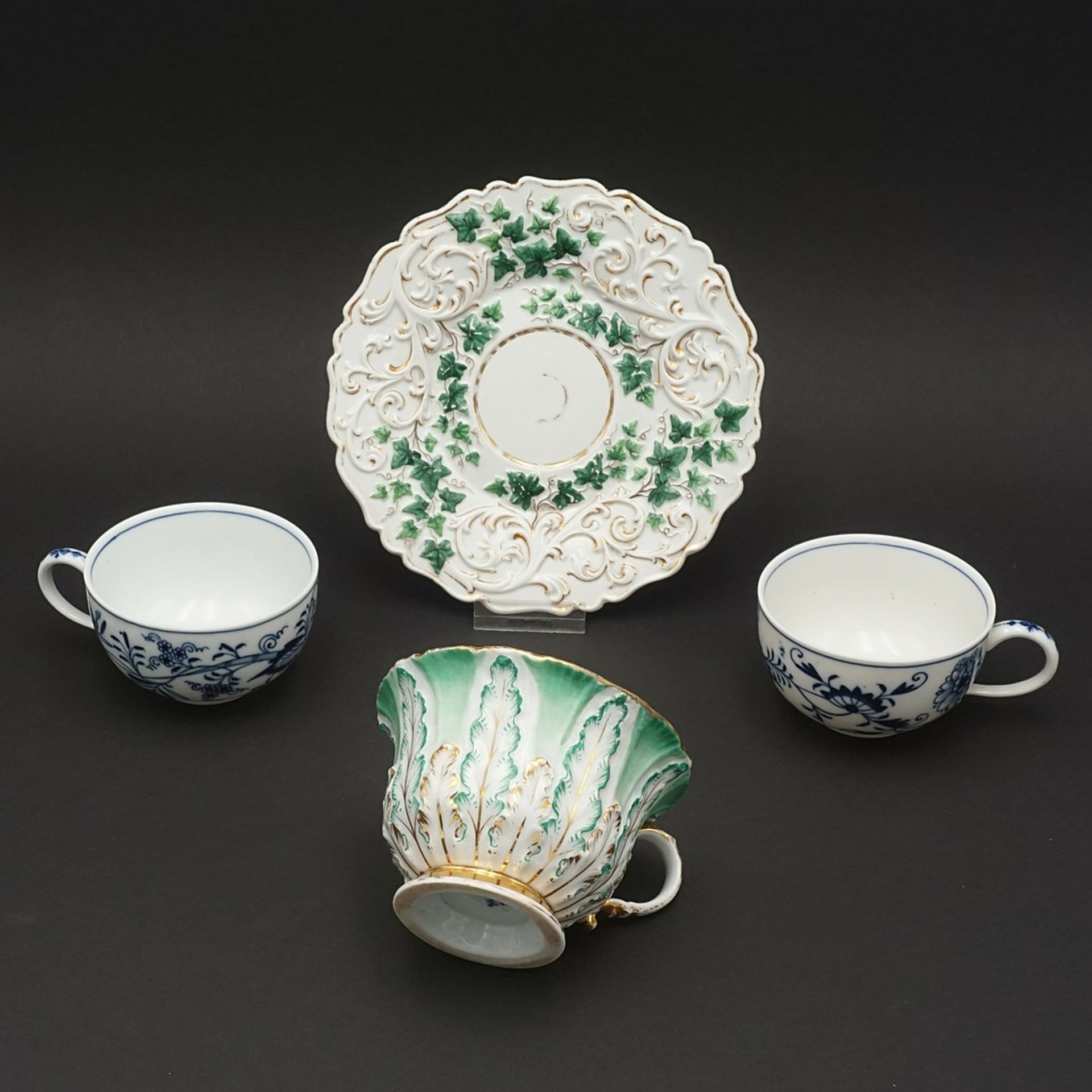 Three Meissen cups and a saucer