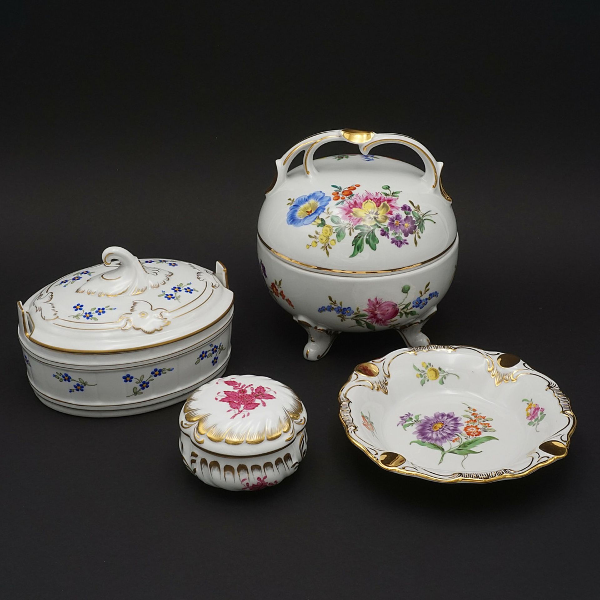 Three lidded boxes and an ashtray with flower painting