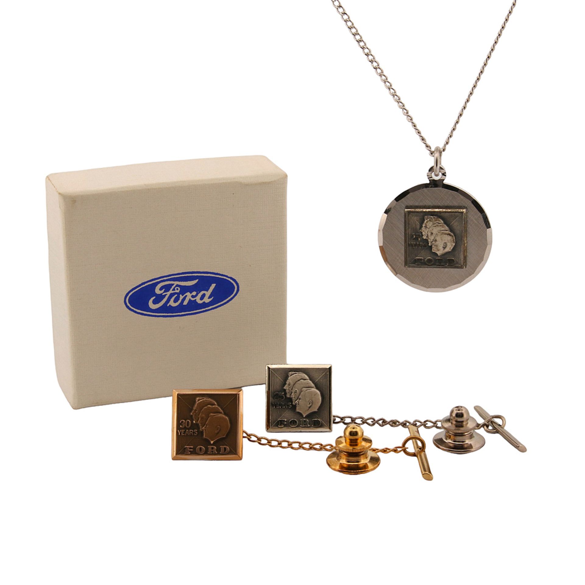 Two tie pins and a pendant with chain ?25 / 30 Years Ford?