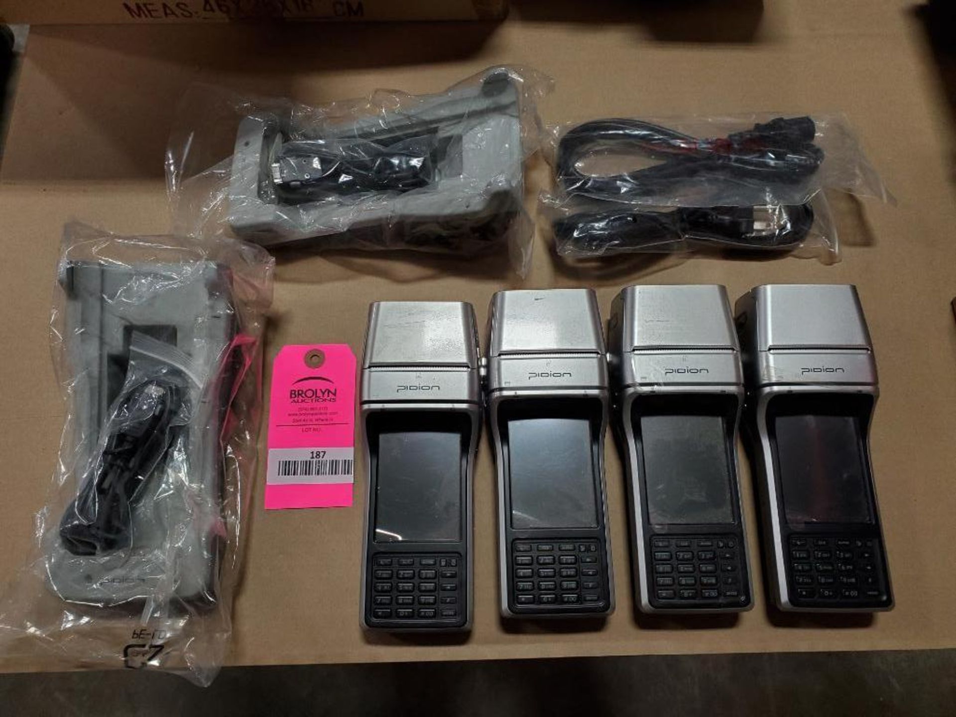 Assorted Psion Bluebird BIP-1300 transaction mobile computer and charge station.