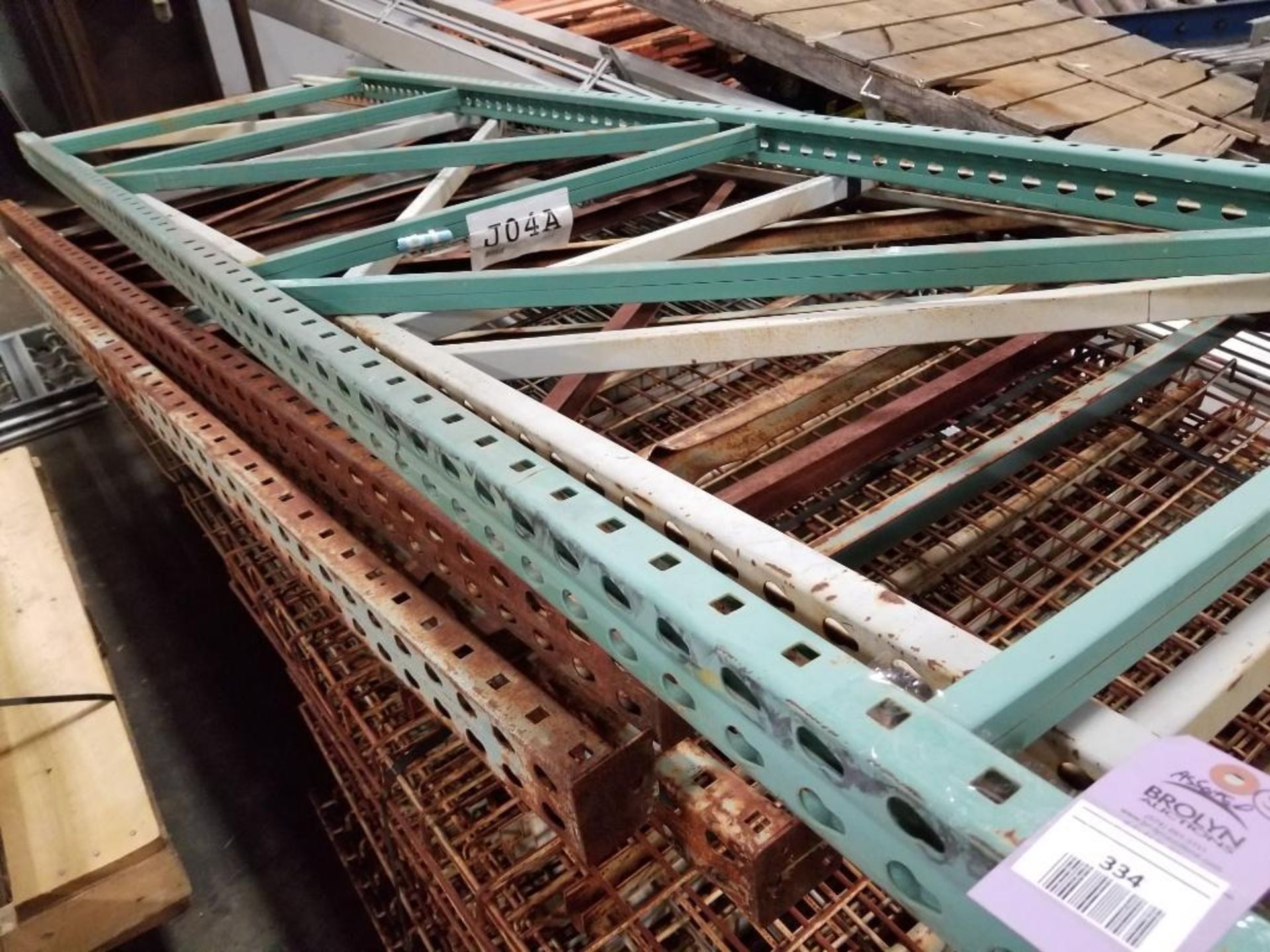 Assorted pallet racking uprights and metal decking.