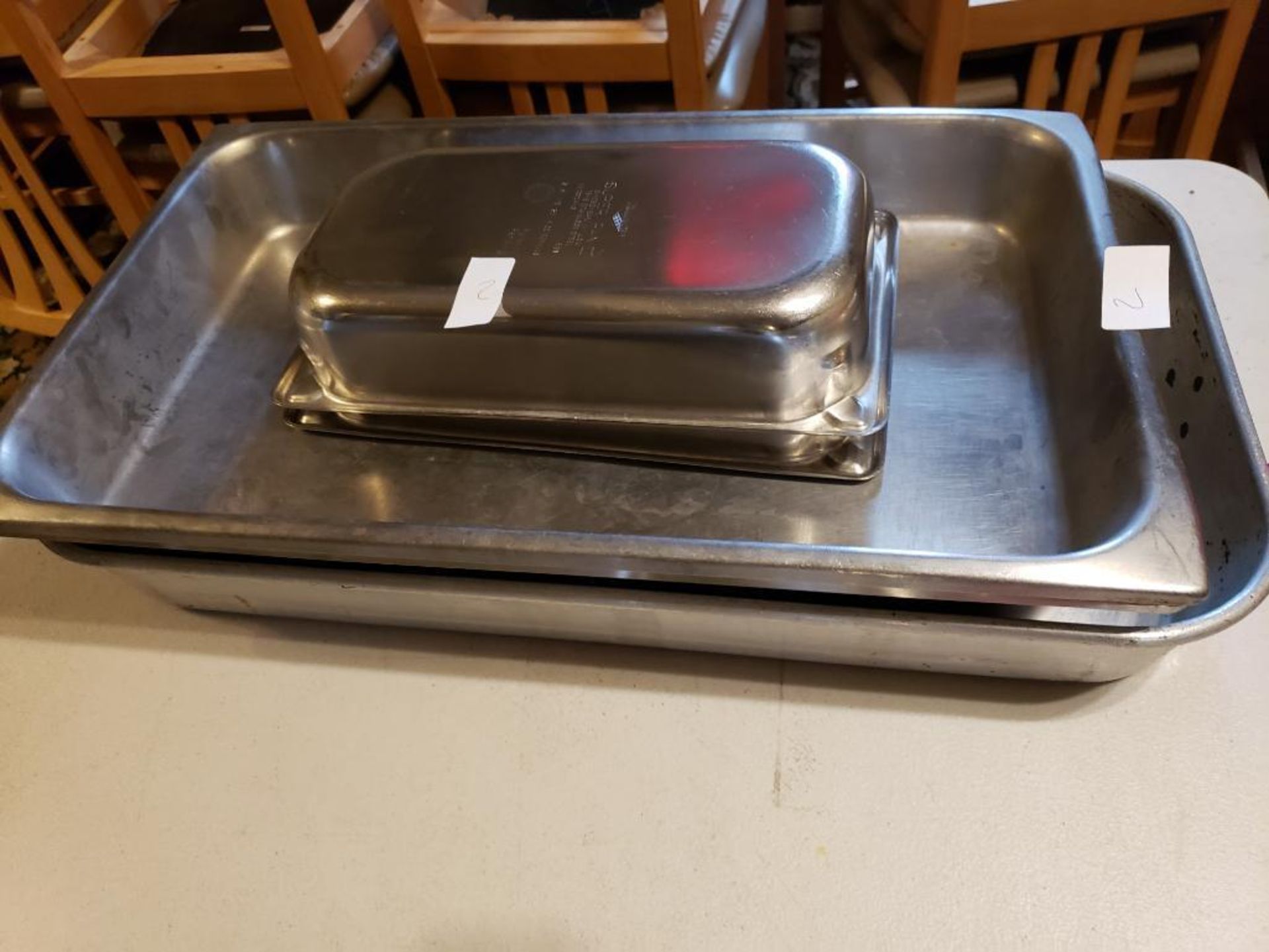Assorted stainless steel steam pans.