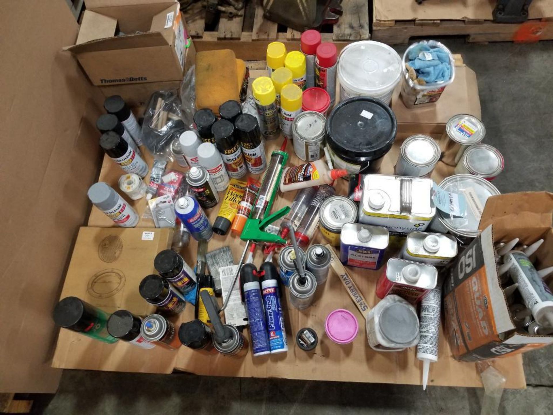 Pallet of assorted paint, sealant.