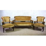 A late Victorian three piece parlour suite, comprising a settee and two bow arm chairs, circa