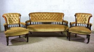 A late Victorian three piece parlour suite, comprising a settee and two bow arm chairs, circa