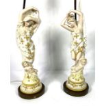 A pair of Continental porcelain figures of classical ladies with attendant putti, later set on