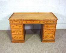 A Victorian satin birch kneehole desk, late 19th century, with a three quarter galleried rectangular