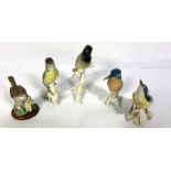 A large assortment of ceramics, including decorative birds, commemorative china, including a