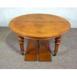 A Victorian oak oval extending dining table, late 19th century, with two additional leaves, and